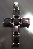 4 retangular and 1 rounded garnet stone in religious cross design sterling silver pendant